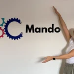 Learnt so far at Mando - Jess outside Mando sign