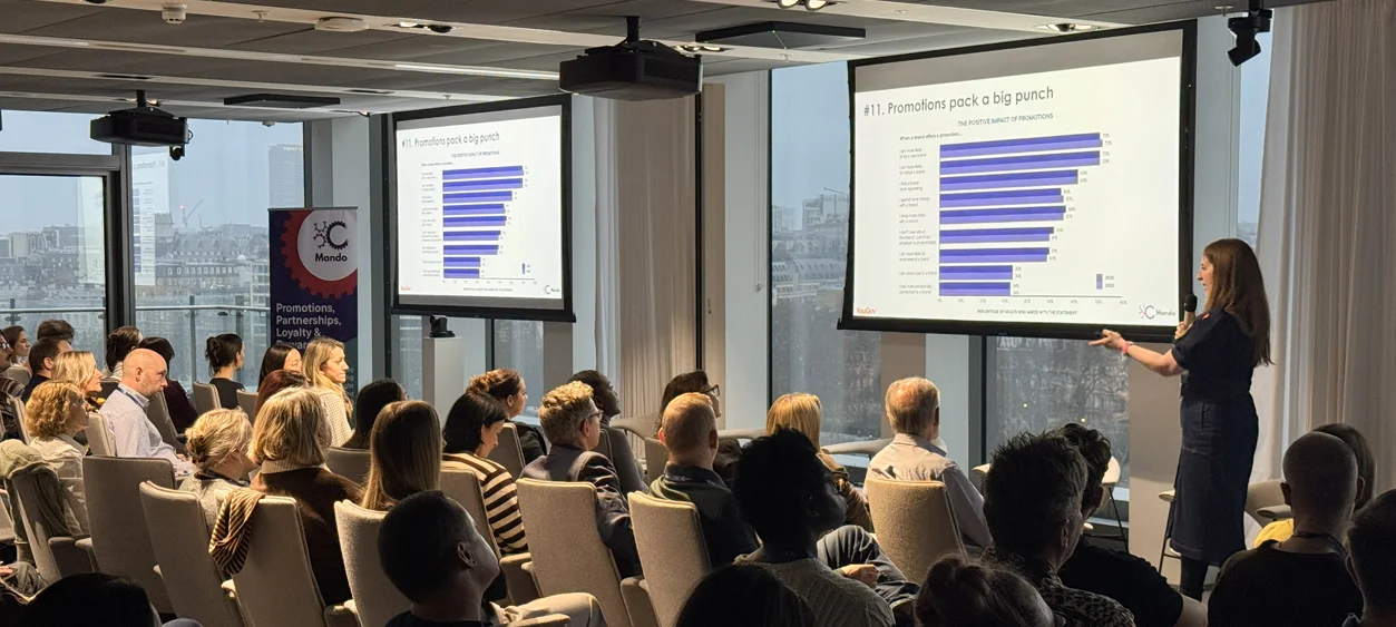 Plan the Perfect Promotion: Charlie Hills presenting the white paper data to a room full of people at Power Up Your Promotions