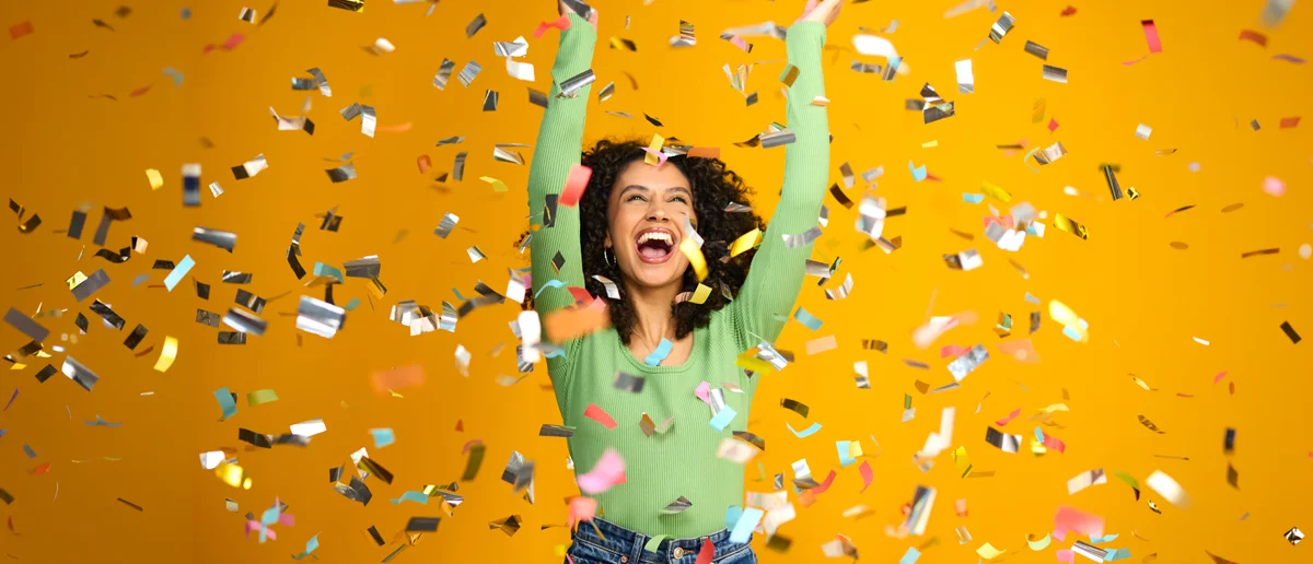 Digital Incentives for Marketing Campaigns: lady looking very happy surrounded by confetti after a reward win