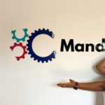 What I've Learnt At Mando: Emilia standing in front of Mando sign in the office