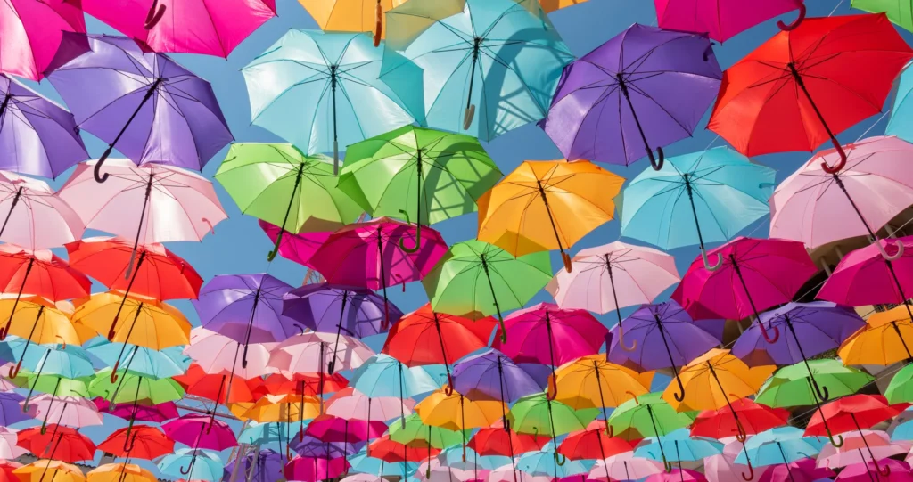 What is a Fixed Fee: Colourful umbrellas covering and protecting the street below them