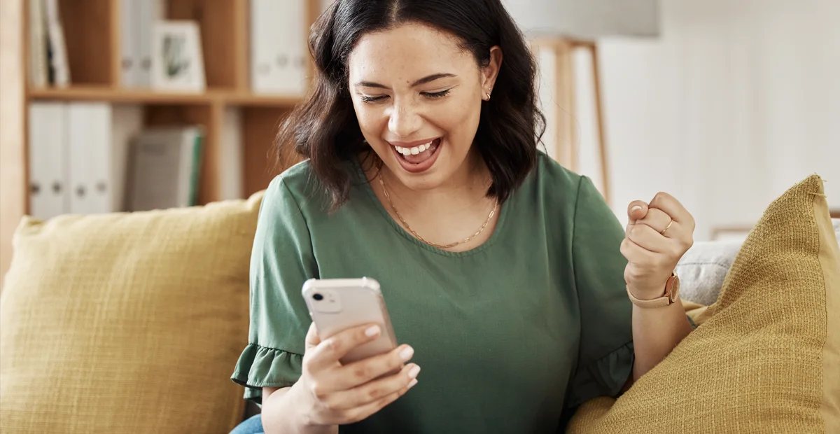 Deliver Rewards Globally: Lady celebrating her win on her phone